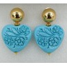 Vergulde oorbellen uitgesneden licht blauw resin hart