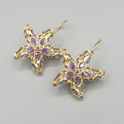 Vergulde oorbellen zeester paarse crystals