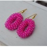 Vergulde oorbellen met ovale hanger van fuchsia roze kristallen