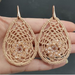 Oorbellen met zalm kleurige hanger van zijdedraad en kristallen