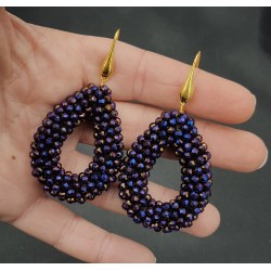 Vergulde oorbellen met open druppel van paars metallic kristallen